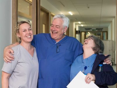Colleagues laughing in a hospital corridor