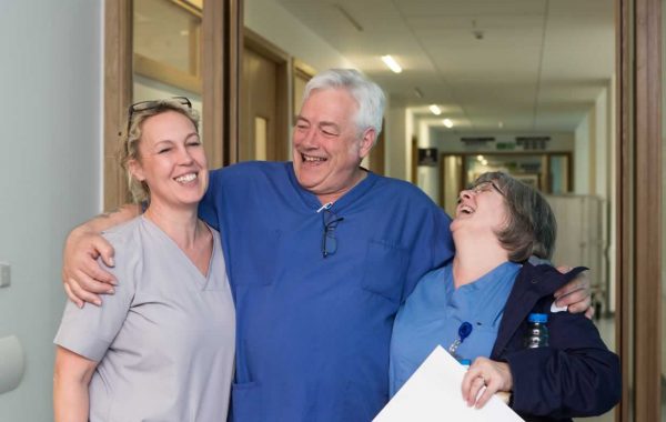 Colleagues laughing in a hospital corridor