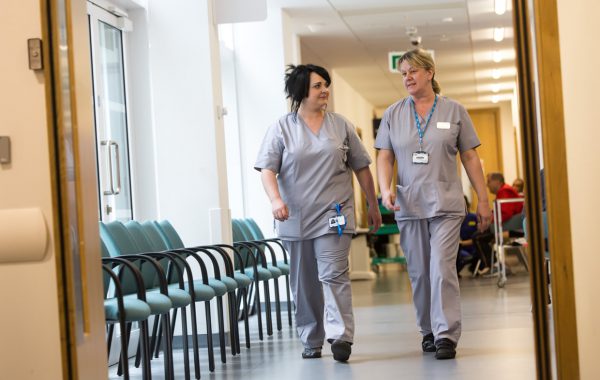 Healthcare professionals walking in a hospital corridor