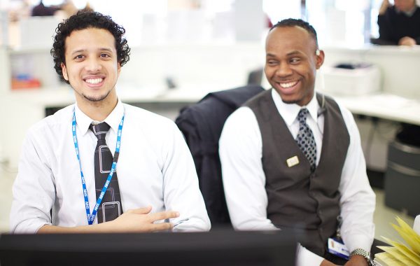 Two staff members at a reception desk