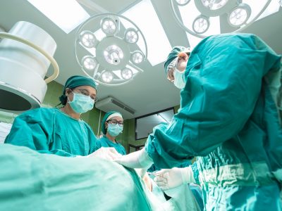 Surgeons with patient in operating theatre