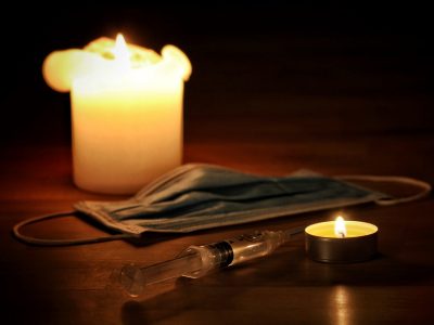 A face mask, candles and syringe