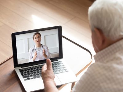 A doctor and older patient having a video call