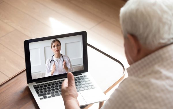 A doctor and older patient having a video call