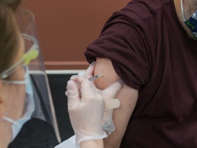 A man receives a COVID-19 vaccination