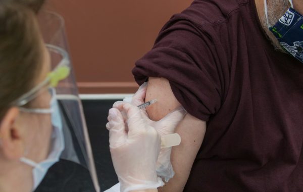 A man receives a COVID-19 vaccination