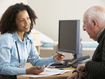 A GP talks to a patient