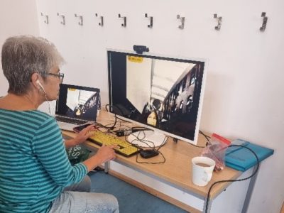 Festival volunteer Wendy operating the Telepresence Robot through a desktop computer