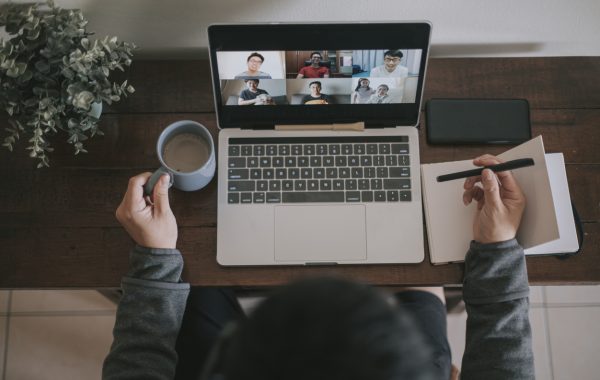 Person using their laptop to take part in a meeting online