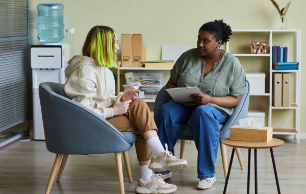 A mental health practitioner is speaking with a young person