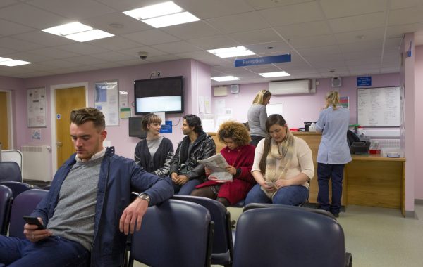 Patients in a waiting room at a GP surgery