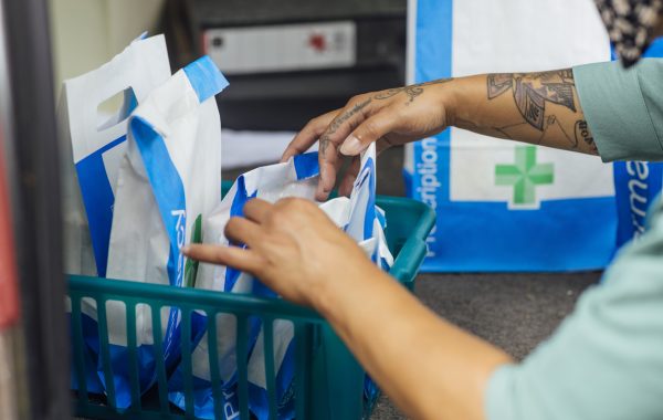 A pharmacy employee is reviewing prescription medication packs