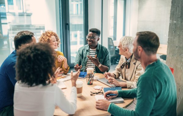 A diverse group of people having a meeting around a table